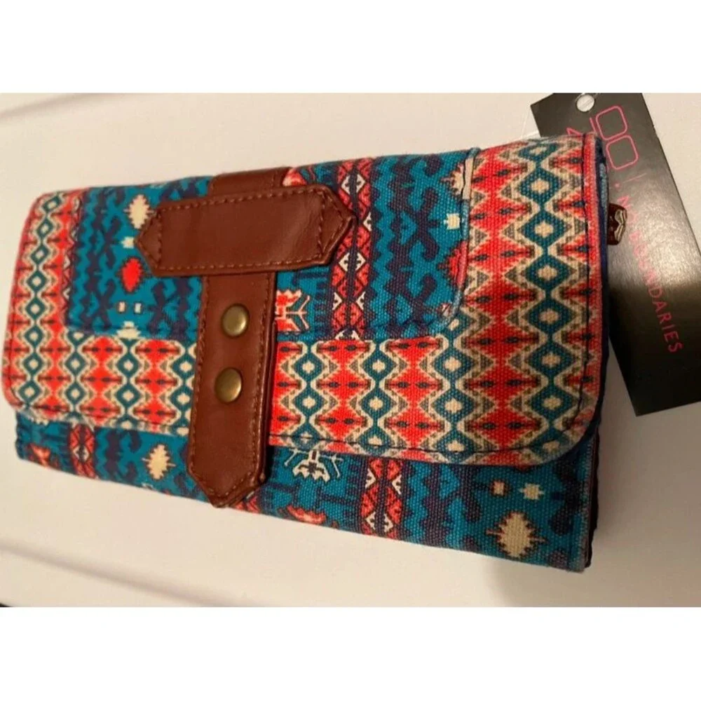 multi-colored Aztec-inspired print and a brown faux leather button strap wallet